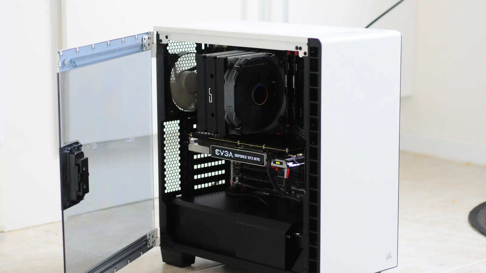 A custom-built desktop PC with its side panel open, showing the CPU cooler and graphics card.