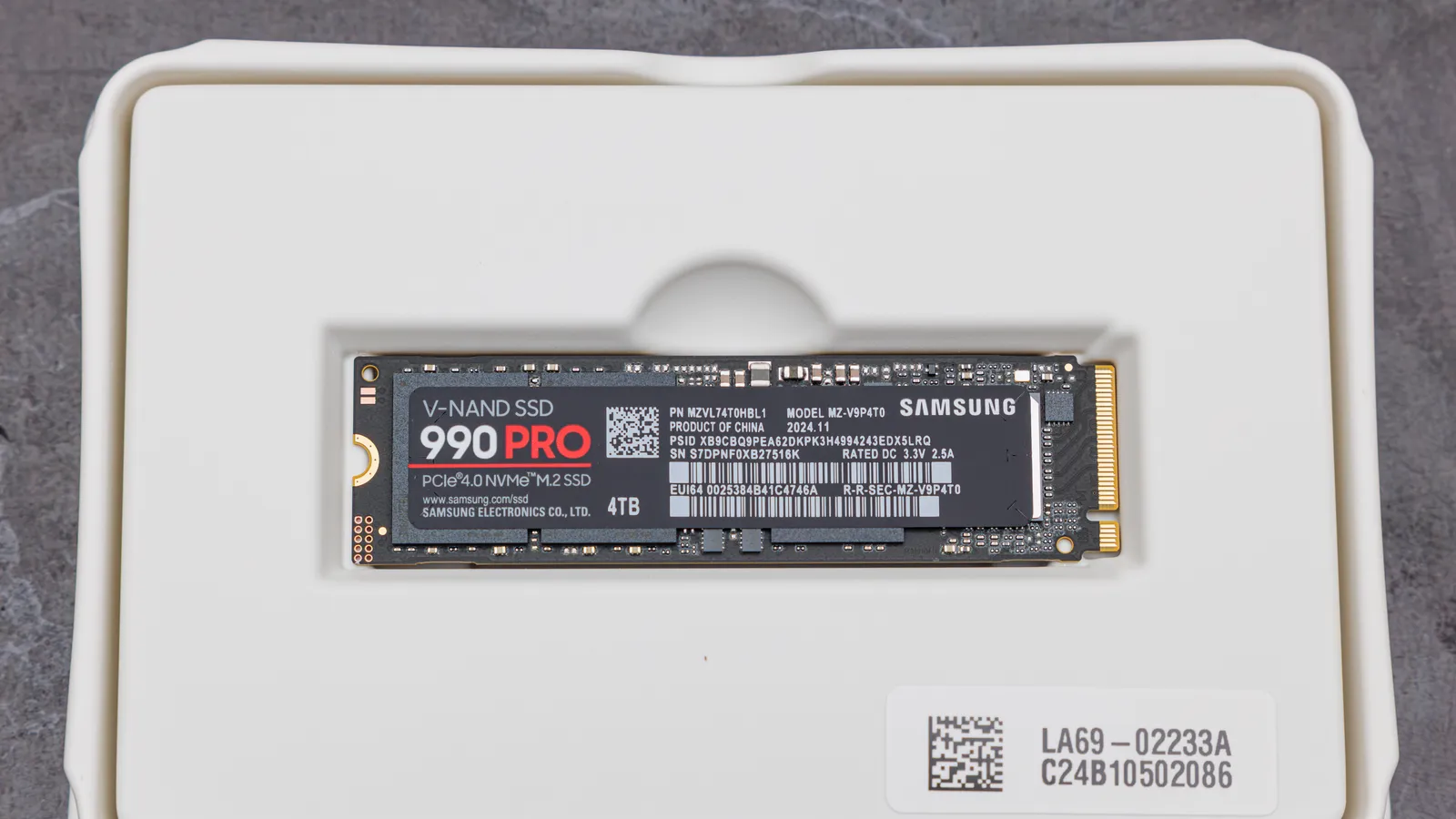 A Samsung 990 PRO 4TB M.2 NVMe SSD in its retail packaging tray